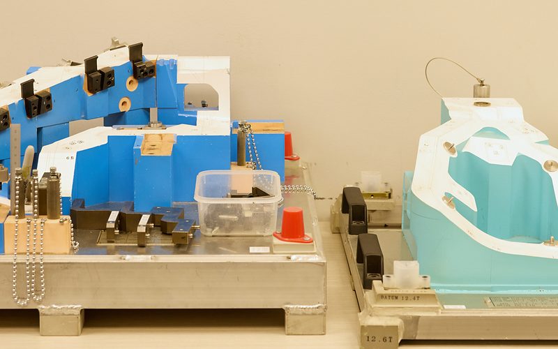 Blue and teal checking fixtures used to verify the dimensions of molded parts